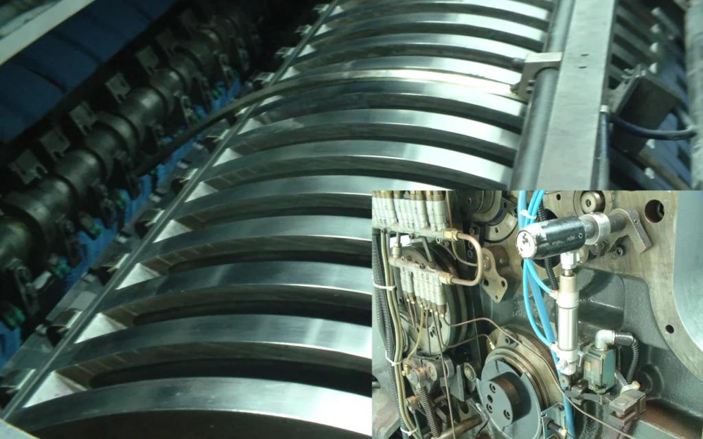 Detalle de cilindros y sistema de pinzas de una máquina de impresión offset Heidelberg con modificaciones técnicas para mejora de rendimiento.